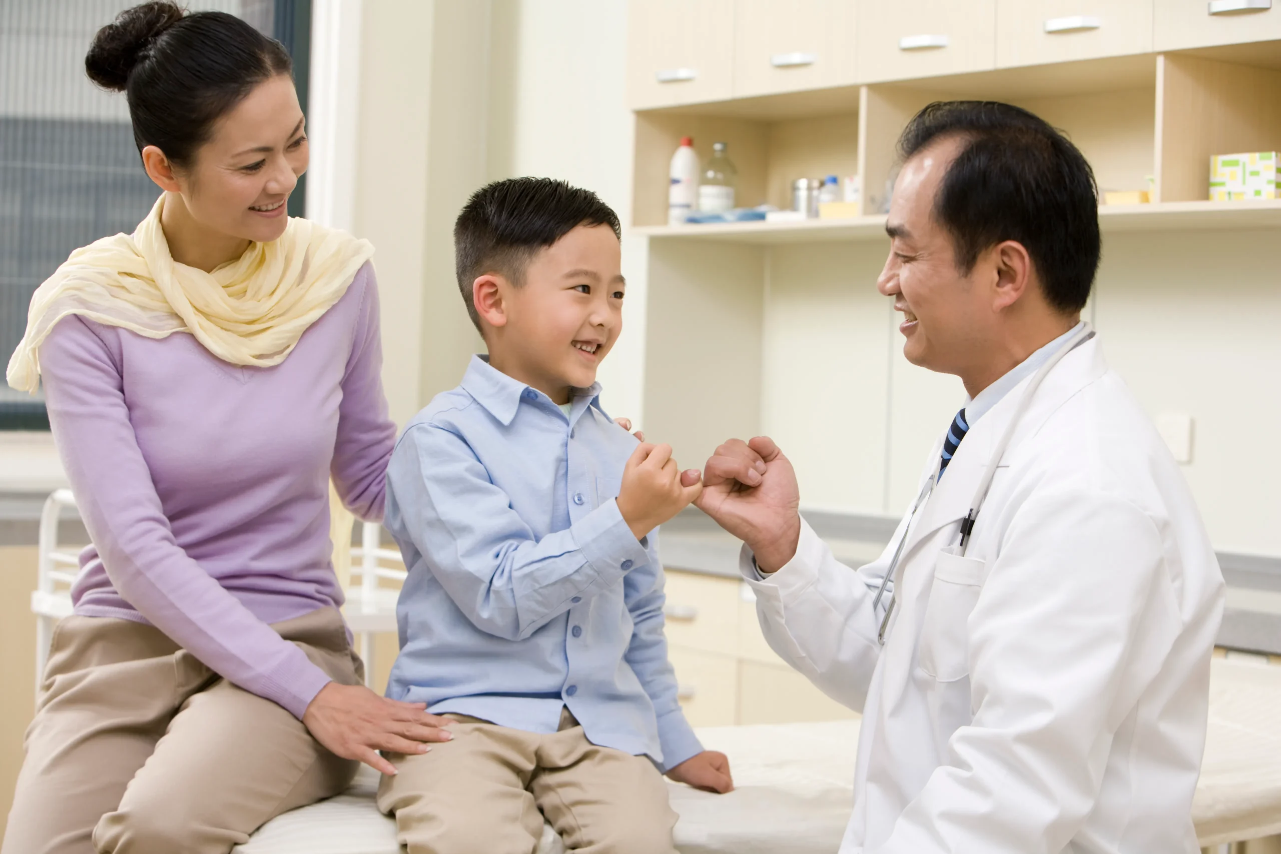 young boy with mother and doctor before kids circumcision malaysia