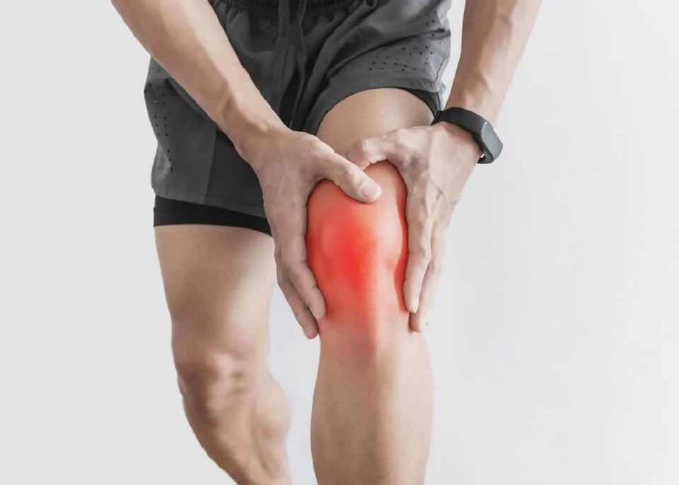 a person holding a knee