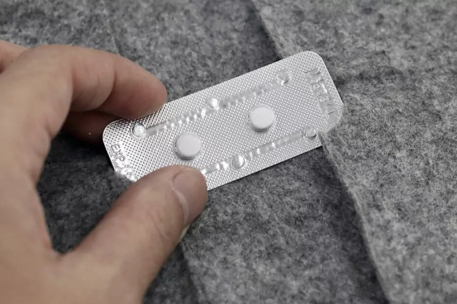 a person holding a pill