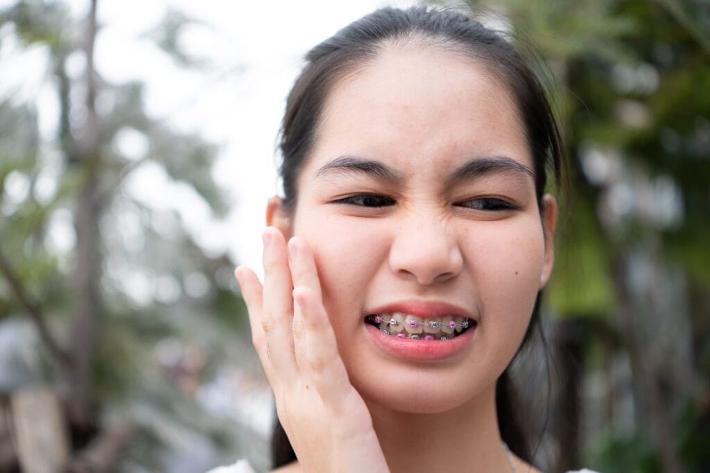 portrait of a young asian woman with braces on her 2023 12 30 02 22 24 utc scaled 1