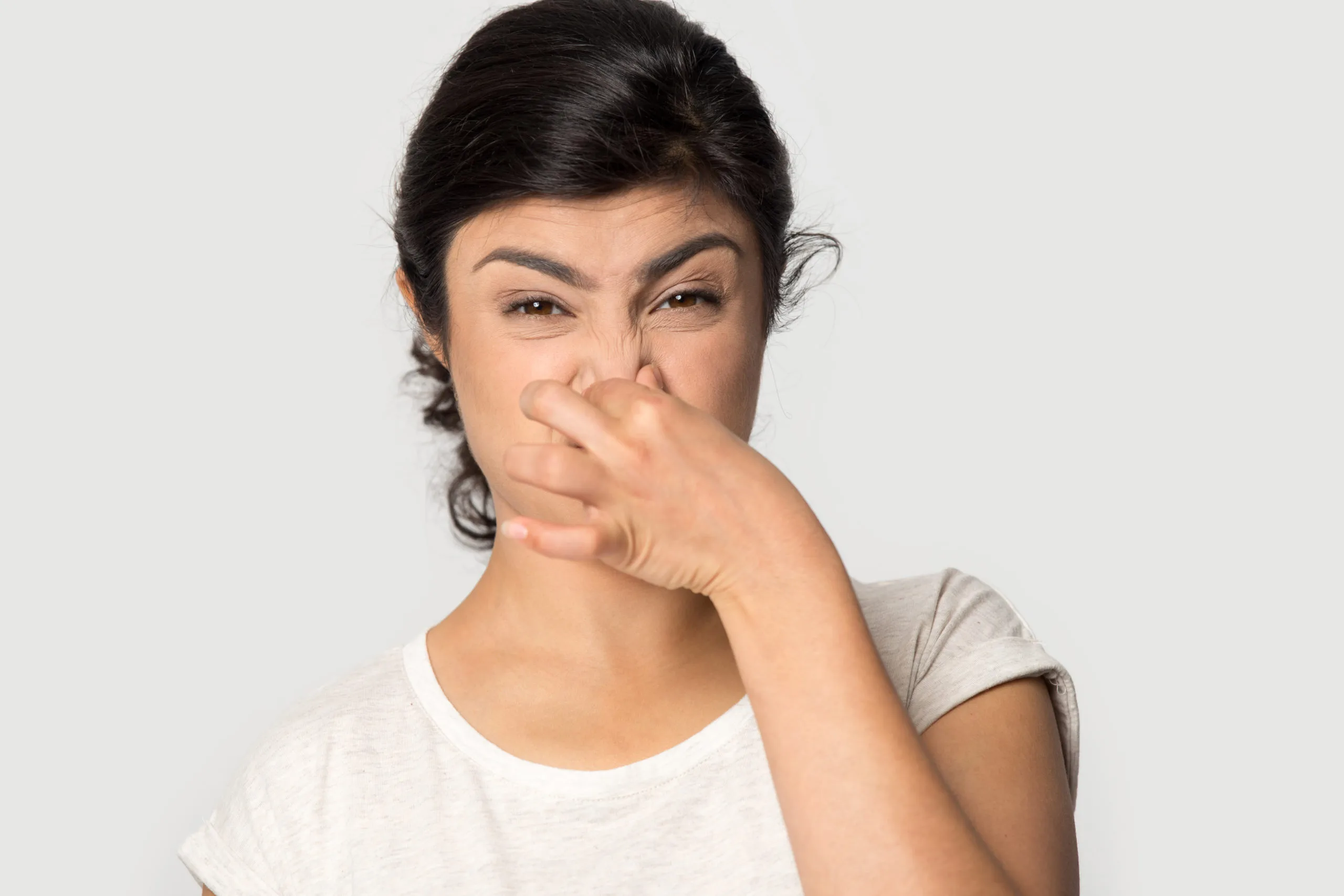 A woman shielding her mouth with her hand, conveying a sense of surprise or concern